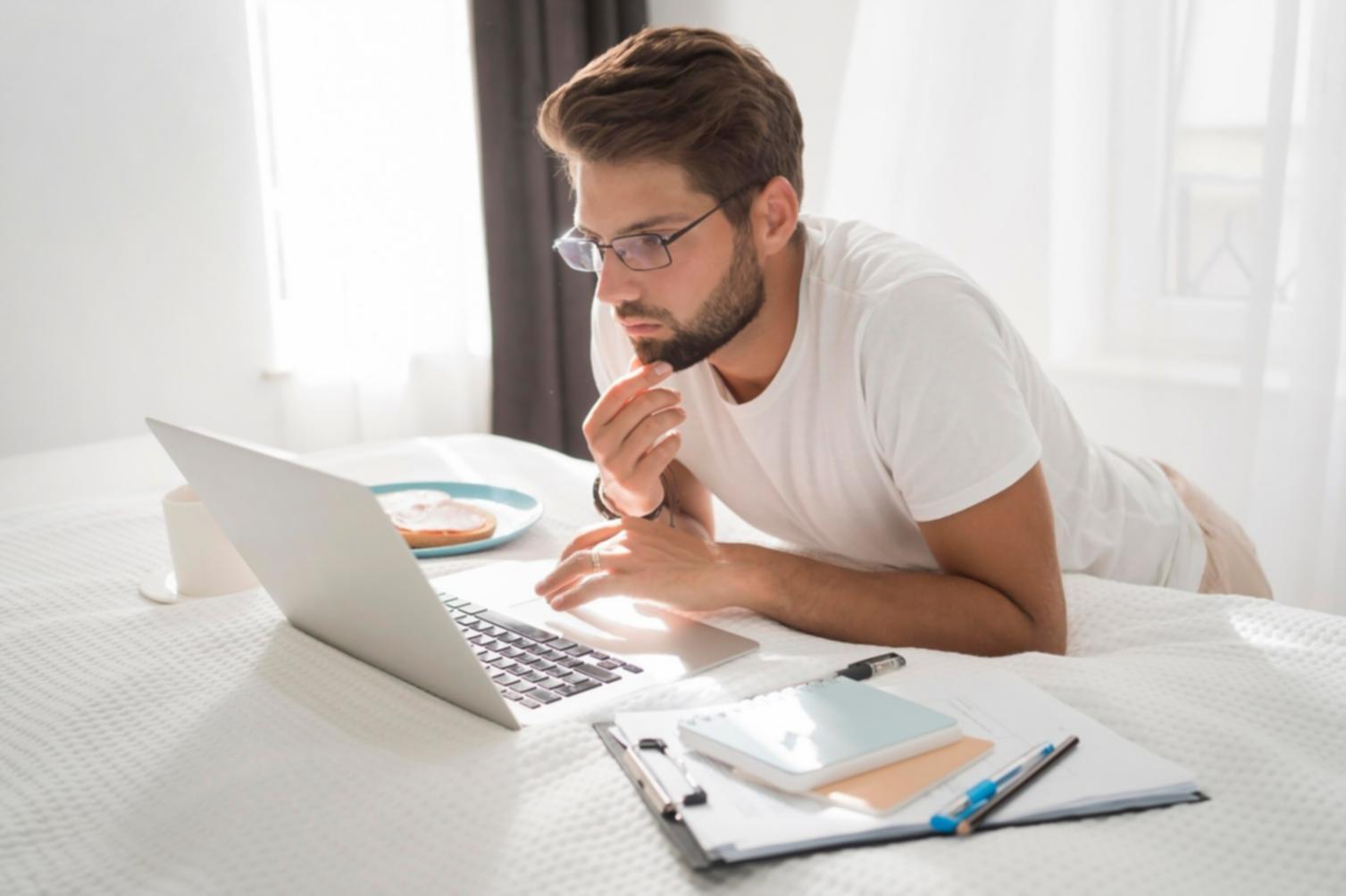 Participant working through financial planning exercises at desk with laptop and notebook